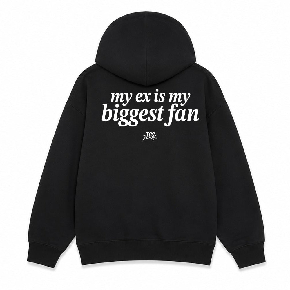 A black pullover hoodie shown from both the front and back on a plain white background. The front has small white text on the left chest reading 'very ex is my biggest fan', and the back has larger white text reading 'my ex is my biggest fan' with a small black graphic below.