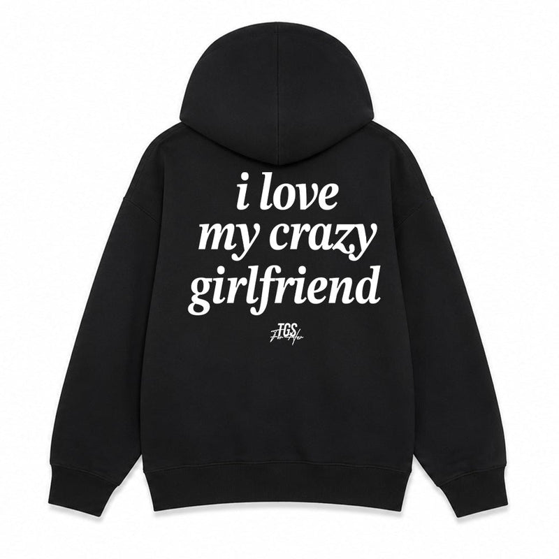 Black pullover hoodie shown from the front and back on a white background. The front has small white text reading 'I love my crazy girlfriend' on the left chest, and the back has large white text reading 'i love my crazy girlfriend' with a small script mark below.